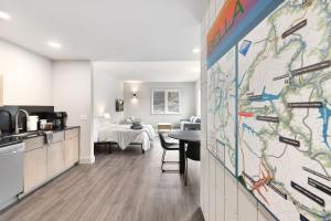 a kitchen and living room with a map on a wall at Sugar Bridge-MTB Oasis in Bella Vista
