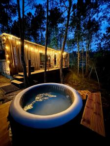 a large bath tub in front of a house at Relax Container in Aguiar da Beira