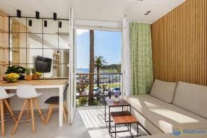 a living room with a couch and a table at Seafront Residence Makarska in Makarska