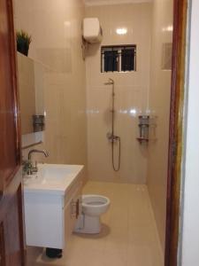 a bathroom with a shower and a toilet and a sink at Paje Home away from home in Paje