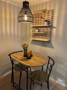 mesa de madera con silla y lámpara colgante en Apartment close to Aalesund center, en Ålesund