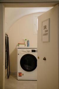 a washer and dryer in a room with a door at La Bella Vita Lecce in Lecce