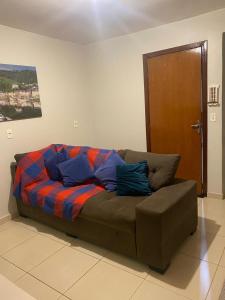 a couch with a colorful blanket on it in a room at Samambaia QI 616 in Brasilia