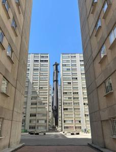 a large statue in the middle of two tall buildings at Excellent Condo/Ideal for Homeoffice in Mexico City