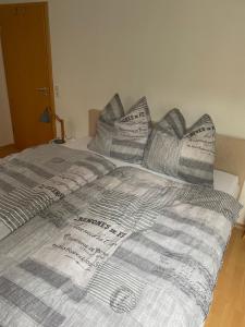 a bed covered in blankets and pillows at City View in Bodenwerder
