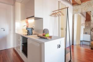 a kitchen with a white refrigerator and a sink at Bandeiras in Porto +26 photos