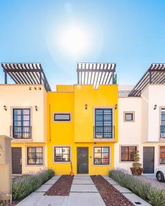 a yellow and white building with a car parked in front at Spyglass San Miguel de Allende 3 Bedrooms 3.5 Bath in San Miguel de Allende