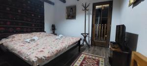 a bedroom with a bed and a television in it at Golemi kamik Pirot Vlasi 2 in Pirot