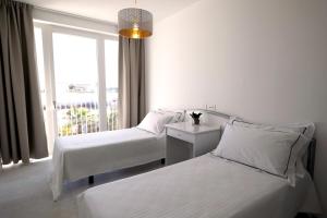 Postel nebo postele na pokoji v ubytování Calammare Apartments - Luxury Apartments with Beach and Gym - Molfetta