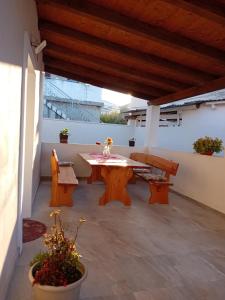 a patio with a wooden table and benches at Tina in Pula