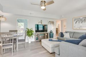 a living room with a couch and a table at Emerald Coast Getaway Near Boardwalk and Breweries! in Fort Walton Beach