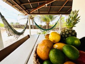 a bowl of fruit on a table with a view of the beach at La Casita Atins in Atins