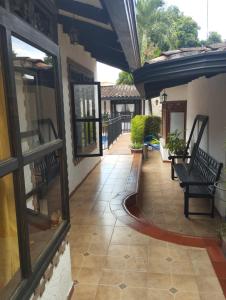 a patio with a bench on a house at Hotel y Restaurante Casa Medina in La Plata +41 photos