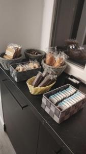 a table with several baskets of different types of bread at B&B L'Esquilina in Rome +7 photos