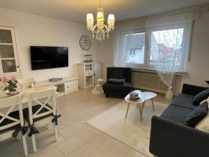 un salon avec un canapé bleu et une télévision dans l'établissement Süße, komfortable Wohnung - 52qm mit Parkplatz, à Rietberg
