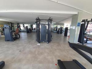a gym with a bunch of equipment in a room at Belo Flat Resort Lake Side Beira Lago in Brasília