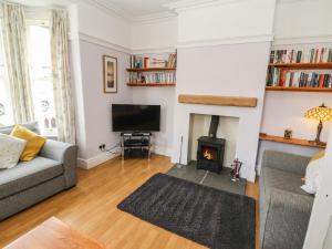 a living room with a couch and a fire place at Pelham House in Keswick