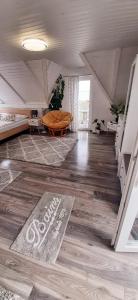 a living room with a wooden floor and a table at Holdfény Apartman in Balatongyörök