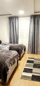 een slaapkamer met 2 bedden en een geruit tapijt bij 3-Zimmer- Wohnung in Traun, nähe Linz und Wels in Linz