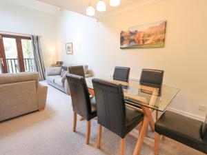 a living room with a dining room table and chairs at Beechside in Ambleside