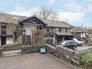 a house with a car parked in a parking lot at Beechside in Ambleside