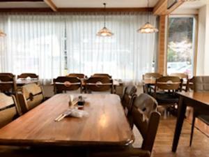 a dining room with a wooden table and chairs at Shoji Mount Hotel - Vacation STAY 78001v in Narusawa