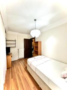 a bedroom with a white bed and a pendant light at Marmaris'te Özel Havuzlu Doğa Manzaralı Villa in Marmaris