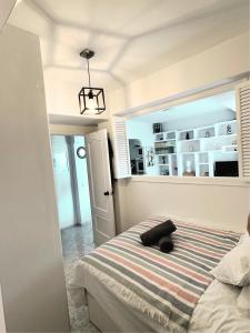 um quarto com uma cama com uma almofada preta em Apartamentos del Fuerte Marbella - Centro y Playa em Marbella