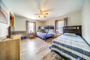 a bedroom with two bunk beds and a ceiling fan at Family-Friendly Hideaway Near Presque Isle! in Erie