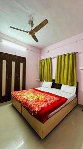 a bedroom with a large bed with a red blanket at Aashapurti Hotel in Aurangabad