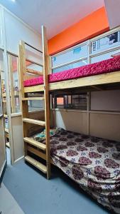 a room with two bunk beds in a house at Aashapurti Hotel in Aurangabad