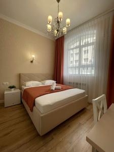 a bedroom with a large bed and a window at Rose Art hotel in Astana