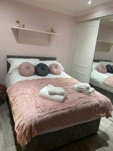 a bedroom with a bed with two towels on it at 3 x Double Bedroomed Apartment, Snaith in Snaith