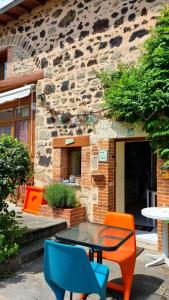 a table and chairs in front of a building at Le Céleste in Châtel-Guyon