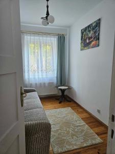 a living room with a couch and a window at Sopot Story in Sopot