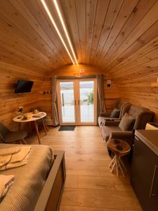 a living room with a couch and a table at Loch View Luxury Pod in Connel