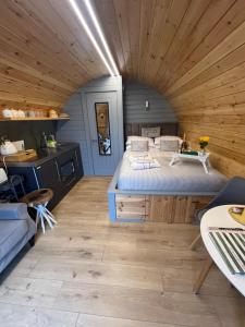 a bedroom with a large bed in a wooden ceiling at Loch View Luxury Pod in Connel
