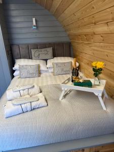 a bed in a room with a table on it at Loch View Luxury Pod in Connel