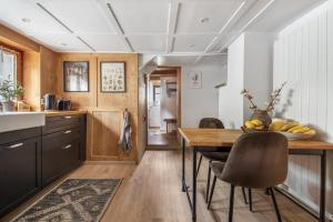 a kitchen with a wooden table and chairs at Casa Pasch - Boutique Bed and Breakfast in Cumpadials in Sumvitg