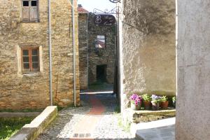 an entrance to an old stone building with potted plants at Borgo del Canto in Borghetto dʼArroscia