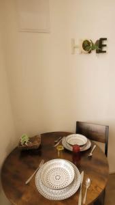 a wooden table with two plates on top of it at Studio B aux pieds des Thermes in Néris-les-Bains