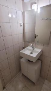 a white bathroom with a sink and a mirror at Studio B aux pieds des Thermes in Néris-les-Bains