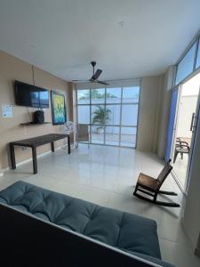 a living room with a couch and a table at Cabanas Villa Antonella Covenas in Coveñas