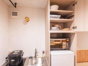 a small kitchen with a sink and a refrigerator at Ashigarashimogun - Glamping - Vacation STAY 64129v in Sengokuhara