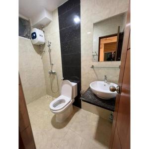 a bathroom with a toilet and a sink at Ocean Apartments Hulhumale (Lot 10819) in Male City
