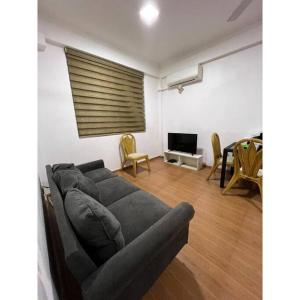 a living room with a couch and a television at Ocean Apartments Hulhumale (Lot 10819) in Male City