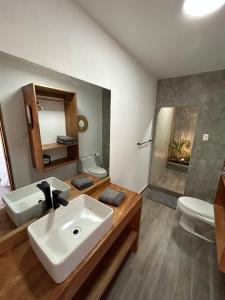 a bathroom with a sink and a toilet at Casa Canoa in Canoas