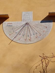 a clock on the side of a building at Casa Asilo La Foce, Val d' Orcia, Pienza. in Pienza +44 photos