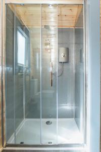 a shower with a glass door in a bathroom at Loch View Luxury Pod in Connel