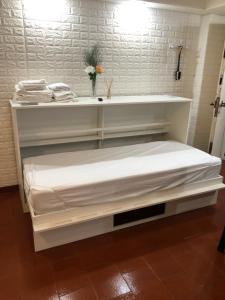a white shelf with a bed in a room at King & Queen in Buenos Aires